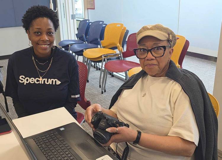 Spectrum mobile customer support HR manager Tiffany Jones helps Glenville resident Carol Brown with some of her laptop and digital camera troubleshooting questions.