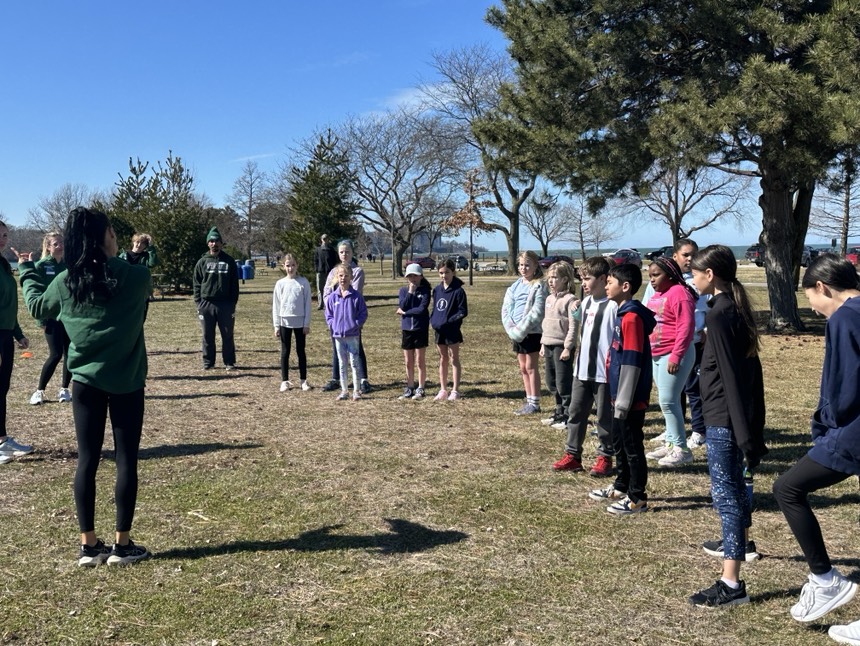 Run Your City Cleveland participants prepare for an exercise at Edgewater Park.