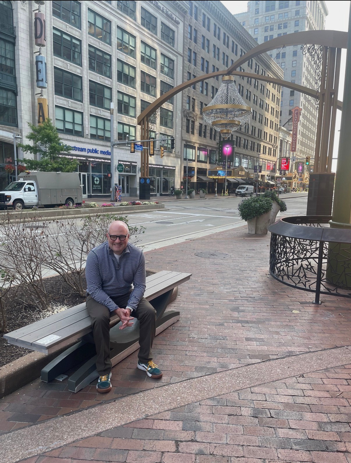 Noblewins founder and CEO Brian Donahue, sitting on the eight-foot-long 'Cuyahoga' bench that he gifted to Jumpstart and Greater Cleveland Partnership.