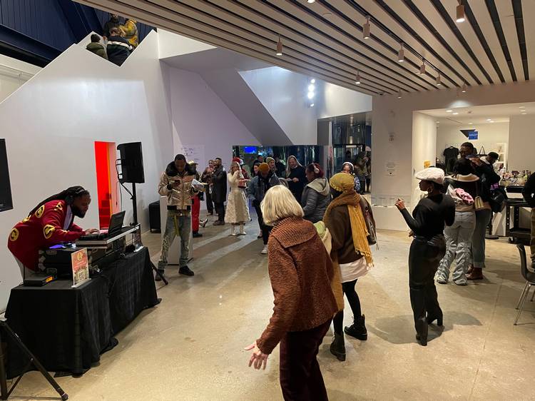 Guests mingle and study the four exhibits at moCa's recent 2026 season opening event.