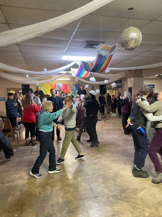 Festival goers dance to the tunes of Fešta Bend in the Slovenian National Home main hall.