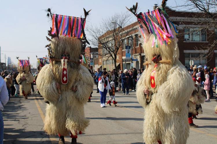 Two Kurenti match down St. Clair Avenue during the 14th annual Cleveland Kurentovanje parade.