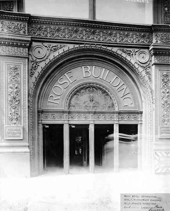 This original, ornate entry was later replaced with a simplified one. Plaques on the left and right advertise the Builders Exchange, located on the third floor before it moved to its own building in the 1930s.