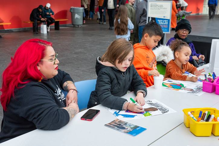 Remember Love Recovery Project making a mini flag to depict our history of protest, care for one another. and contemporary issues.