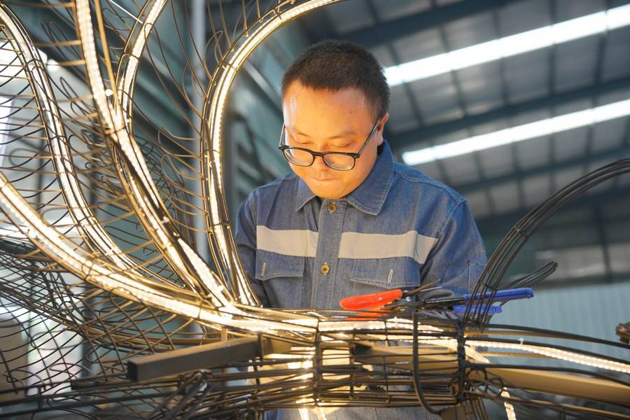 A Taianyu lighting and kinetic designed works on an installation.