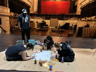 The technical theater crew members build sets.
