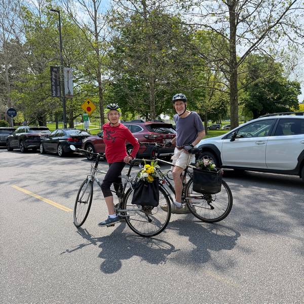 Happy flashers head home on their bikes with their flowers.
