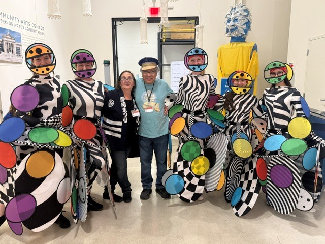 Héctor Castellanos Lara poses with some of the costumed parade participants.