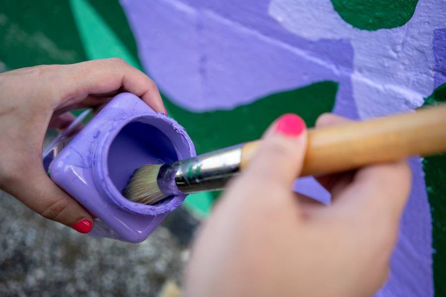 Artist Olivia Oltmanns puts the final touches on her work.