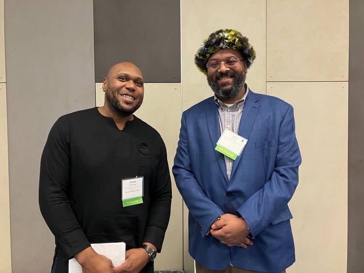 Carasai Ihentuge, left, pitches self-sustaining bioreactors designed for carbon capture in the Climate & Energy Innovation category with sponsor Julian Khan.