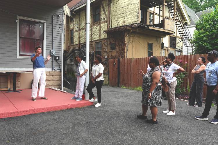 MidTown Cleveland executive director Ashley Shaw greets residents during a walking tour of Hough last summer.