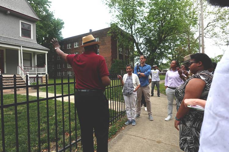 Residents take a Hough waking tour with MidTown Cleveland.