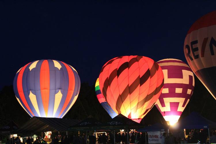 Hot air balloons at night at Blossom Time 2025 in Chagrin Falls.