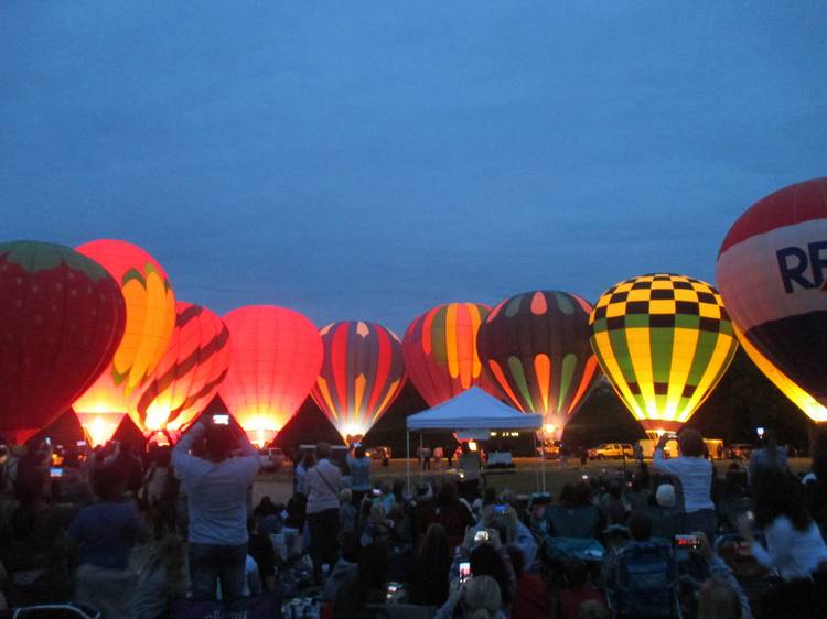 The hot air balloons glow at Blossom Time 2025 in Chagrin Falls.