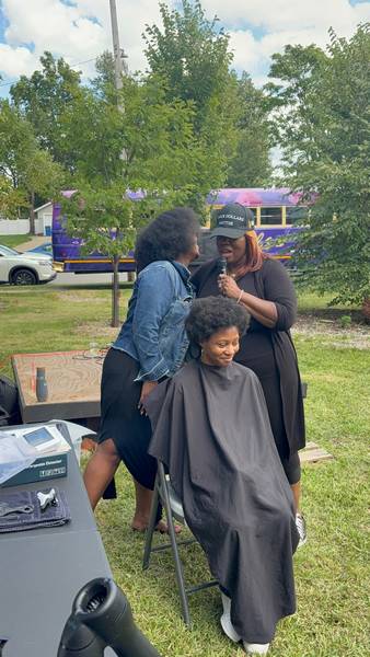 Participants work on styling  afros at World Afro Day Cleveland 2025.