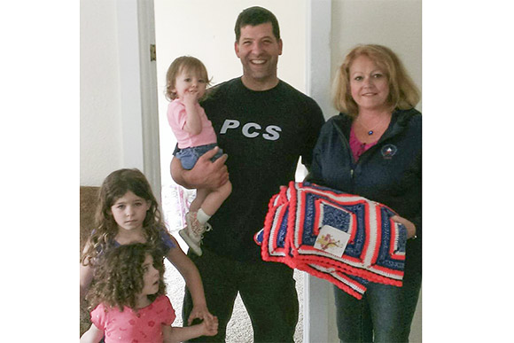 CAVA President Molly Carlin with Army veteran Brian Smith after delivering furniture for him and his daughters