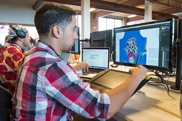 Rage On designer Will Vazquez working on a design