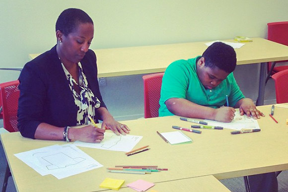 Graphic designer Arlene Watson leads a workshop to create the MOOS visual identity