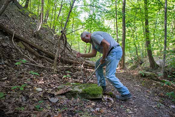 Paul Beno cutting and removing a twisted piece of rebar along the path