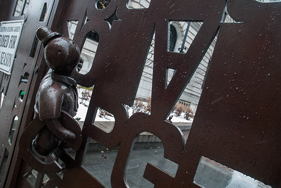 The bronze gate by artist Tom Otterness, with its fragmented alphabet, and whimsical characters
