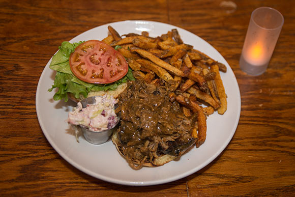 Pulled pork sandwich with fries at  The Rib Cage Smokehouse and Bar