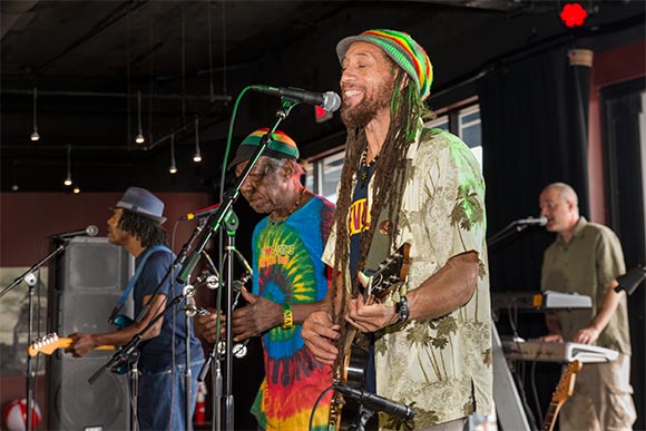 <span class="content-image-text">Carlos Jones performing at Reggae On The River at On Air Studio in the Flats</span>