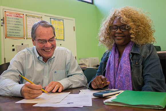 Bruce Smith volunteer adult educator working with Carrie Gary at May Dugan Center’s Education Resources Center