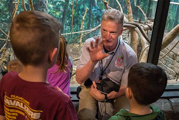 Curator Tad Schoffner talks monkeys with children visitors to the Cleveland Metroparks Zoo