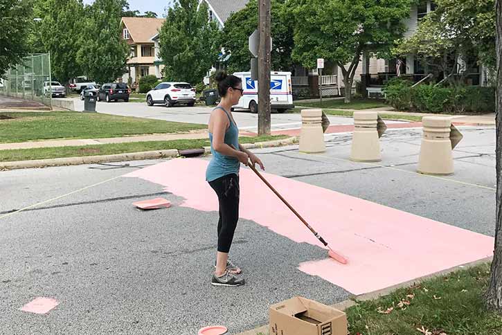Artist Ali Forbes working on the Rosewood Avenue Mural