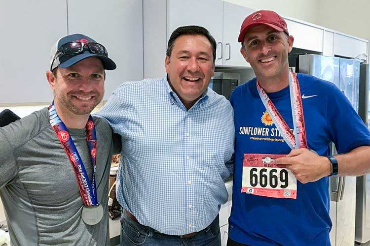 PFM co-founder, Ed McNamara (center) celebrating with Tim Brokaw and friend after the race
