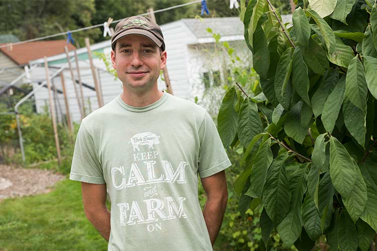 Ronald Kasper of Orchard Grove CSA next to his Pawpaw fruit tree