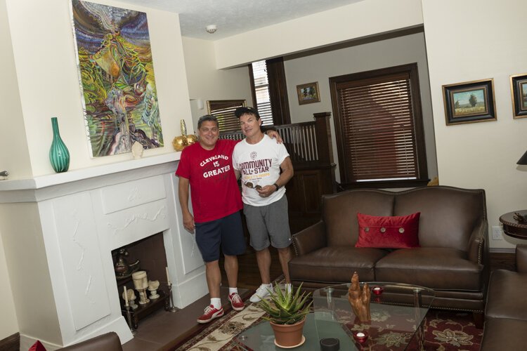 Todd and Dane in their living room with their favorite painting by a good friend in Pittsburgh