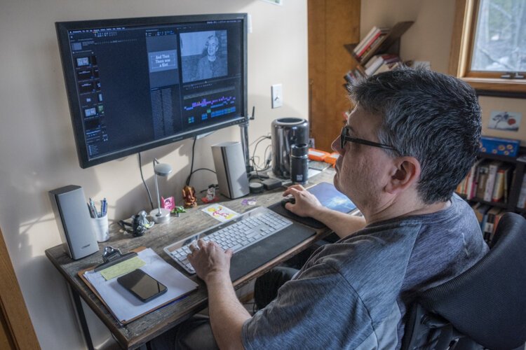 Brad Masi works on video editing at his home in Cleveland Heights.