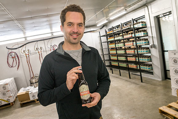 Co-founder Sam McNulty with a bottle of Prosperity