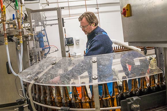 Brewmaster and co-founder Andy Tveekrem overseeing the bottling process