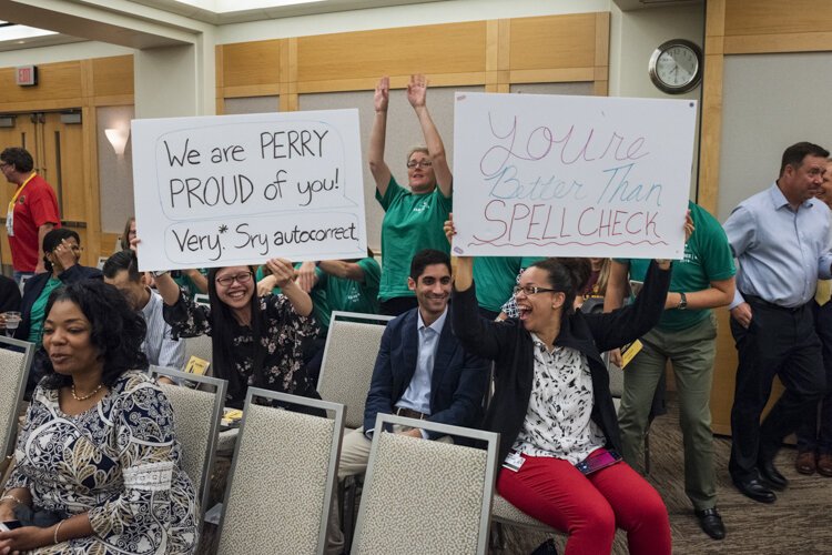 Audience members cheer on their favorite teams.
