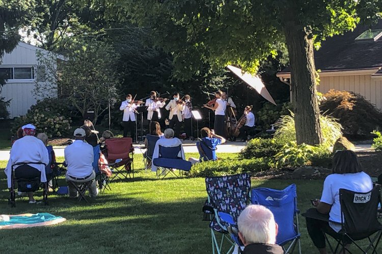 Residents of Bryden Road enjoying classical music on their neighbor’s driveway.