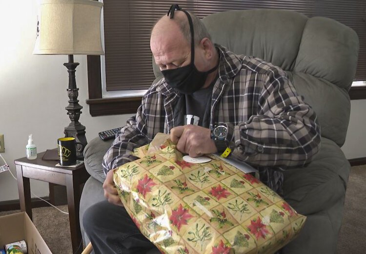 Terrance Dewalt opening a gift from Don Buckholz